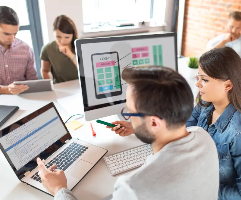 Image of a group of people at a table working collaboratively