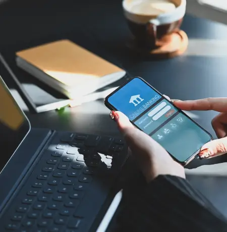 Image of a woman working with a mobile banking app on their phone